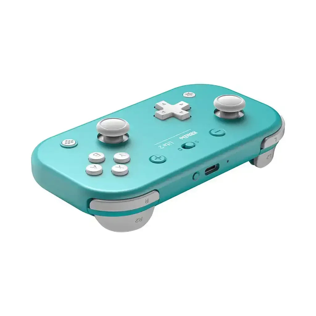 Turkusowy bezprzewodowy gamepad do gier, minimalistyczny design, przyciski i gałki analogowe.