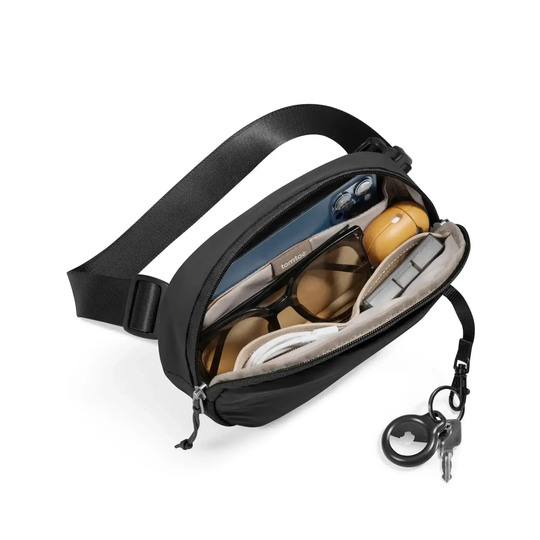 Czarna torba na akcesoria biurowe z okularami, smartfonem i kluczami do home office.