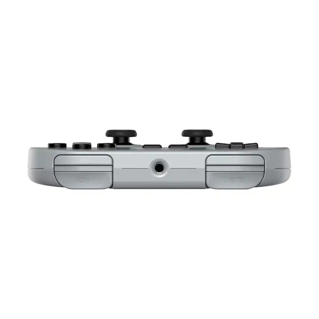 Szary bezprzewodowy gamepad do konsoli z przyciskami i wejściem audio, widok z góry.