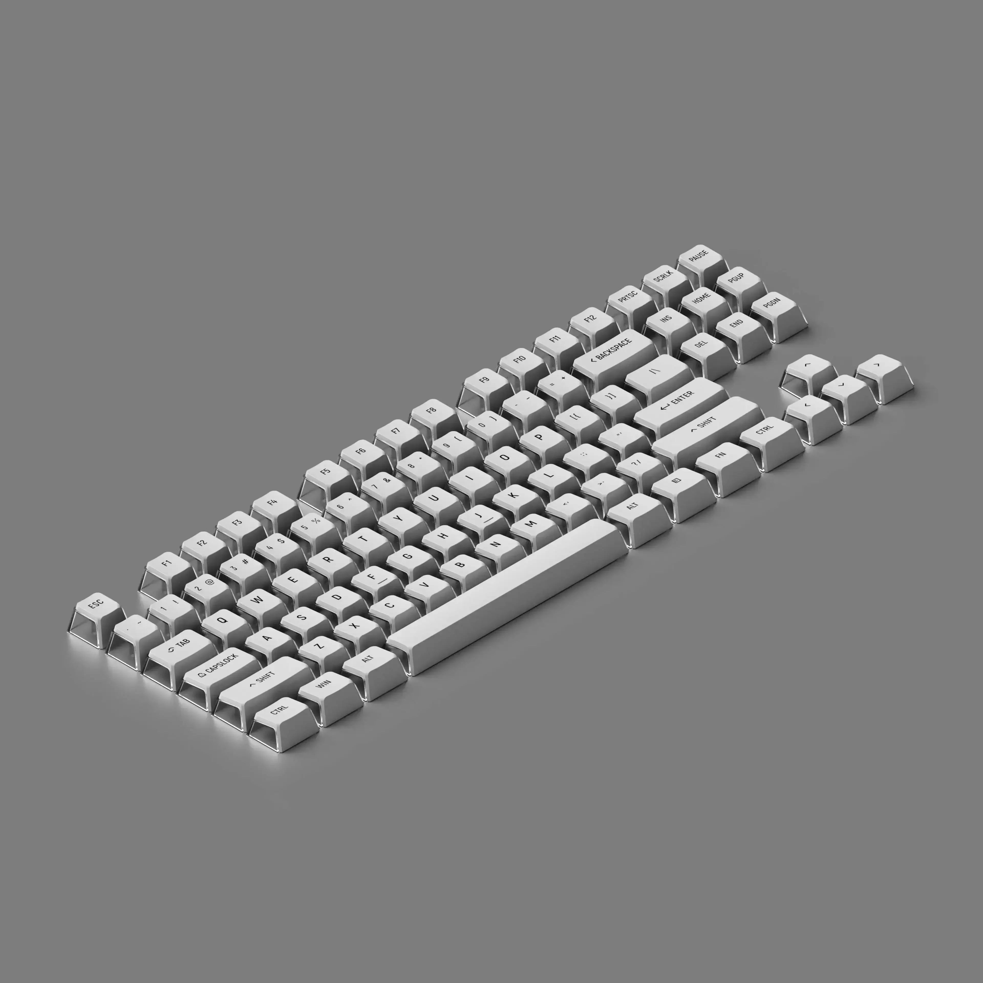 Białe keycapy do klawiatury mechanicznej na szarym tle, akcesoria desk setup