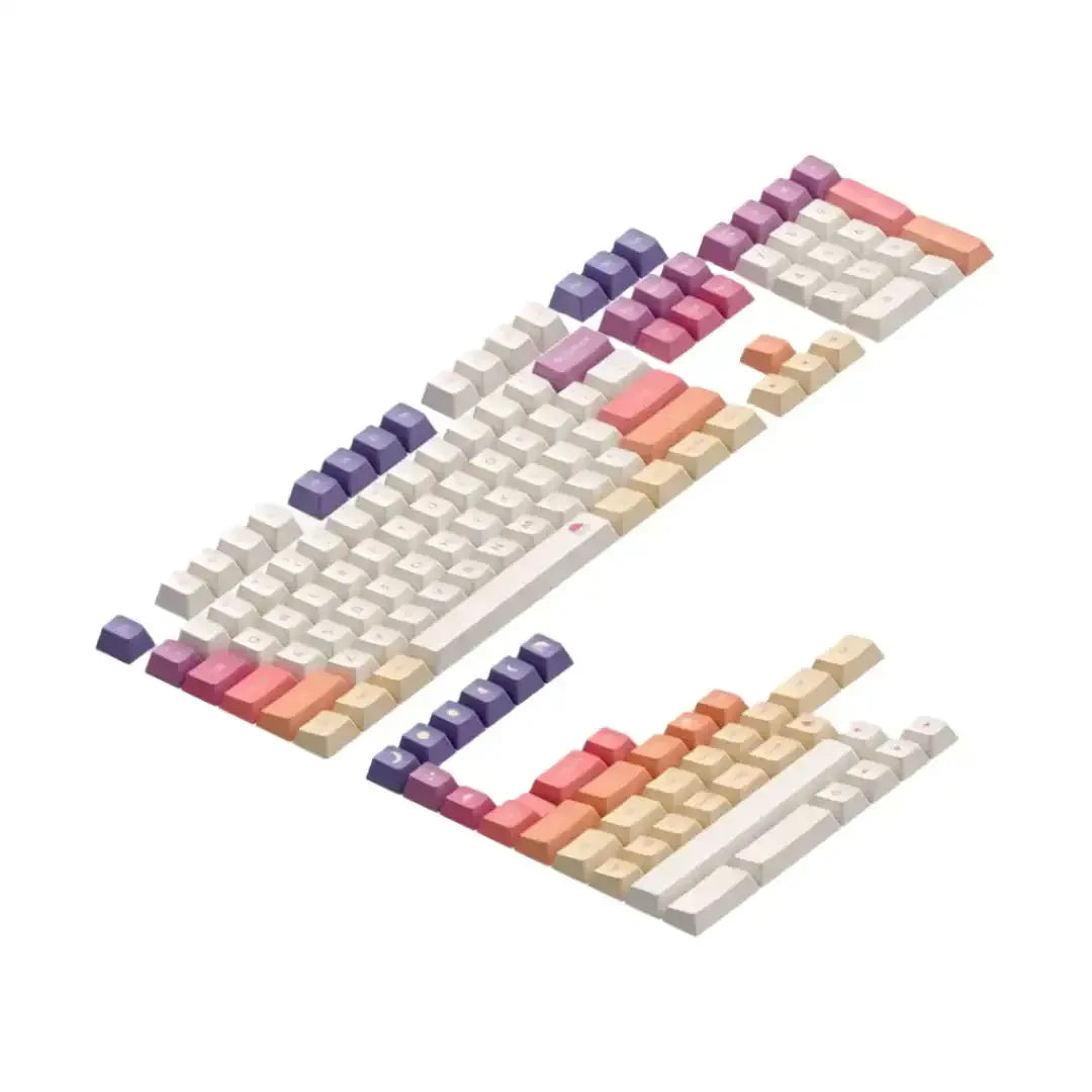 Zestaw keycapów do klawiatury mechanicznej w kolorach kremowym, fioletowym, różowym i pomarańczowym, idealny do personalizacji desk setupu.