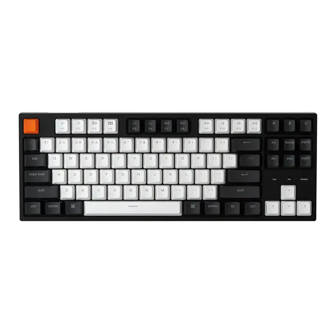 Klawiatura mechaniczna czarno-biała z pomarańczowym klawiszem, idealna do home office.