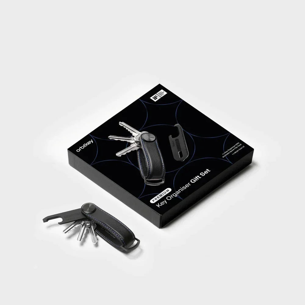 Elegancki organizator kluczy z czarną skórzaną obudową i akcesoriami, idealny do biurka w home office