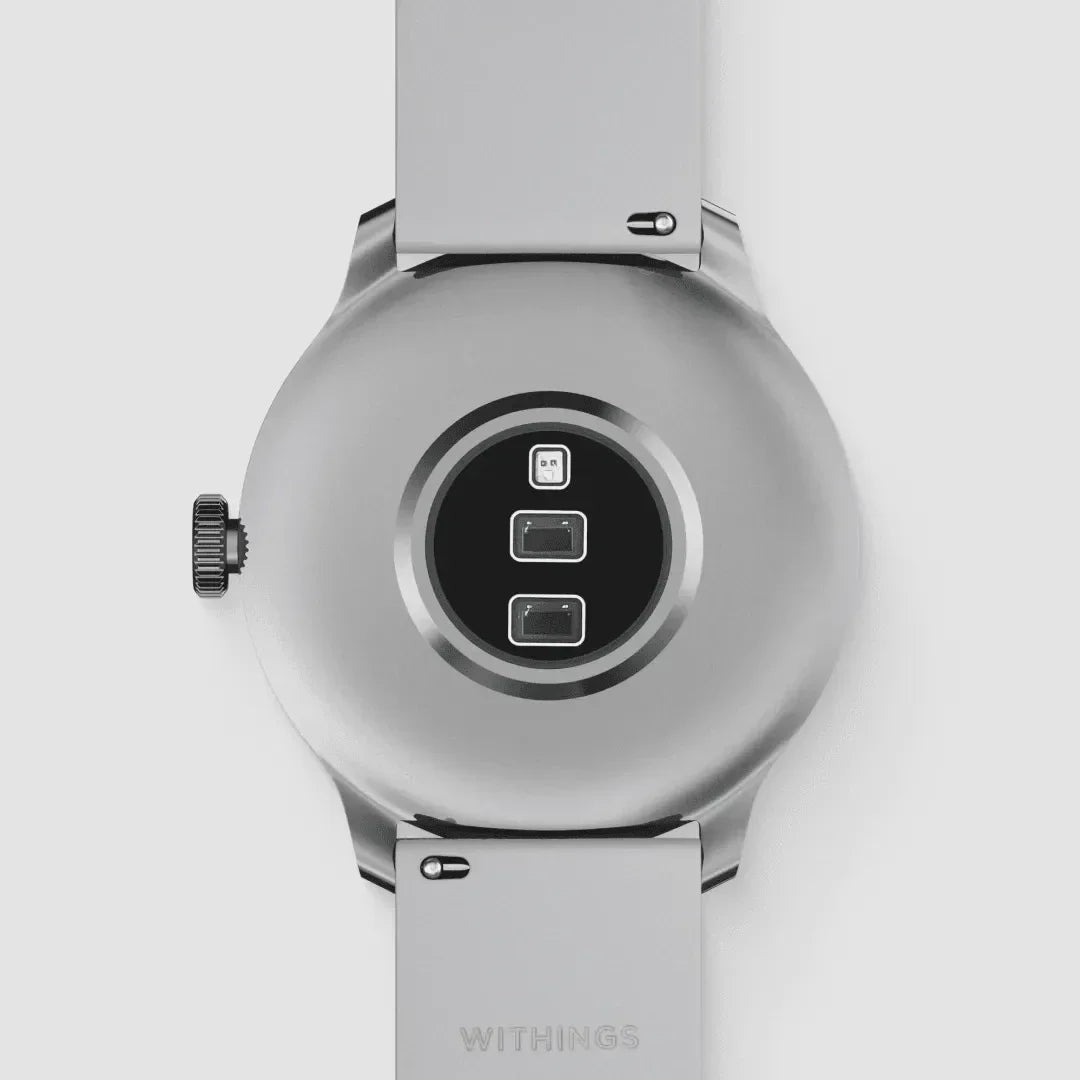 Z tyłu inteligentny zegarek Withings z czujnikami i metalowym paskiem, idealny do home office
