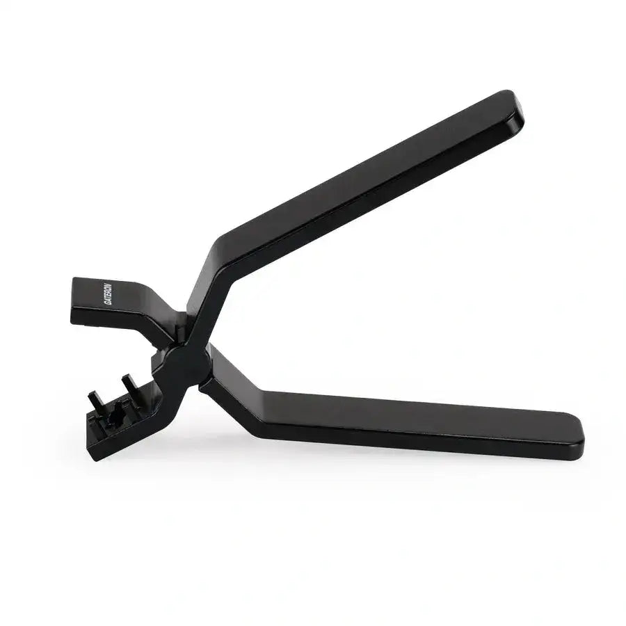 Czarna zaciskarka z dwoma uchwytami i mechanizmem zaciskającym na białym tle