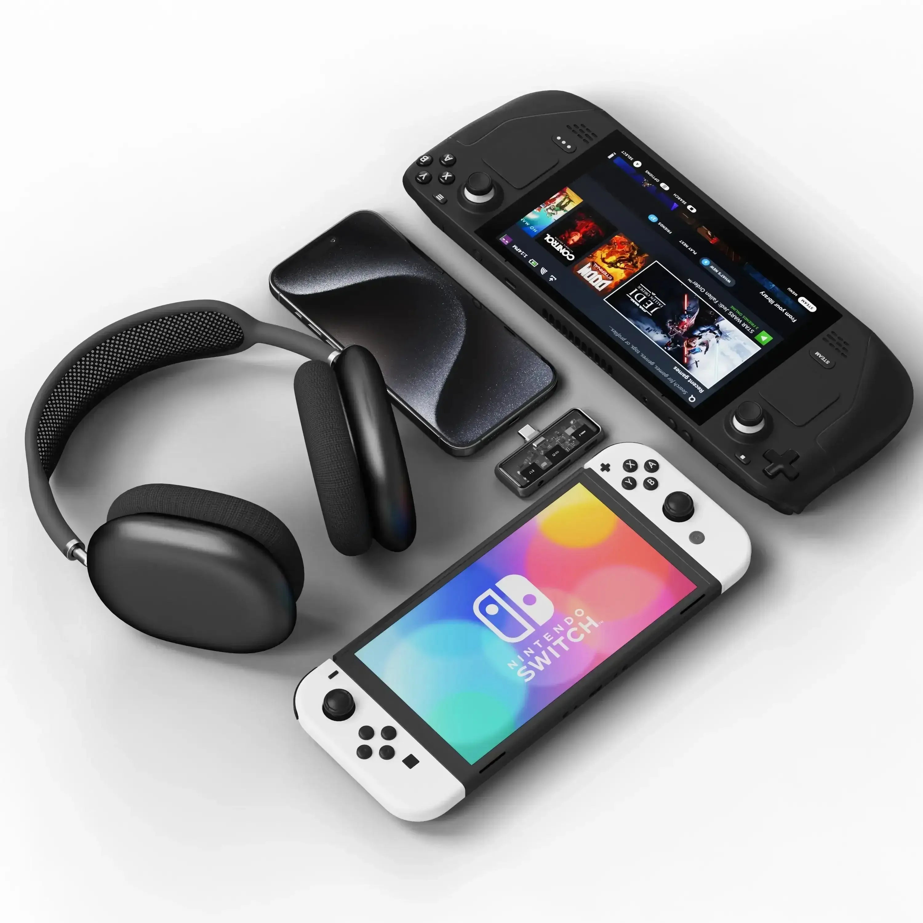 Zestaw: słuchawki bezprzewodowe, telefon, konsola Nintendo Switch, adapter audio, konsola przenośna.