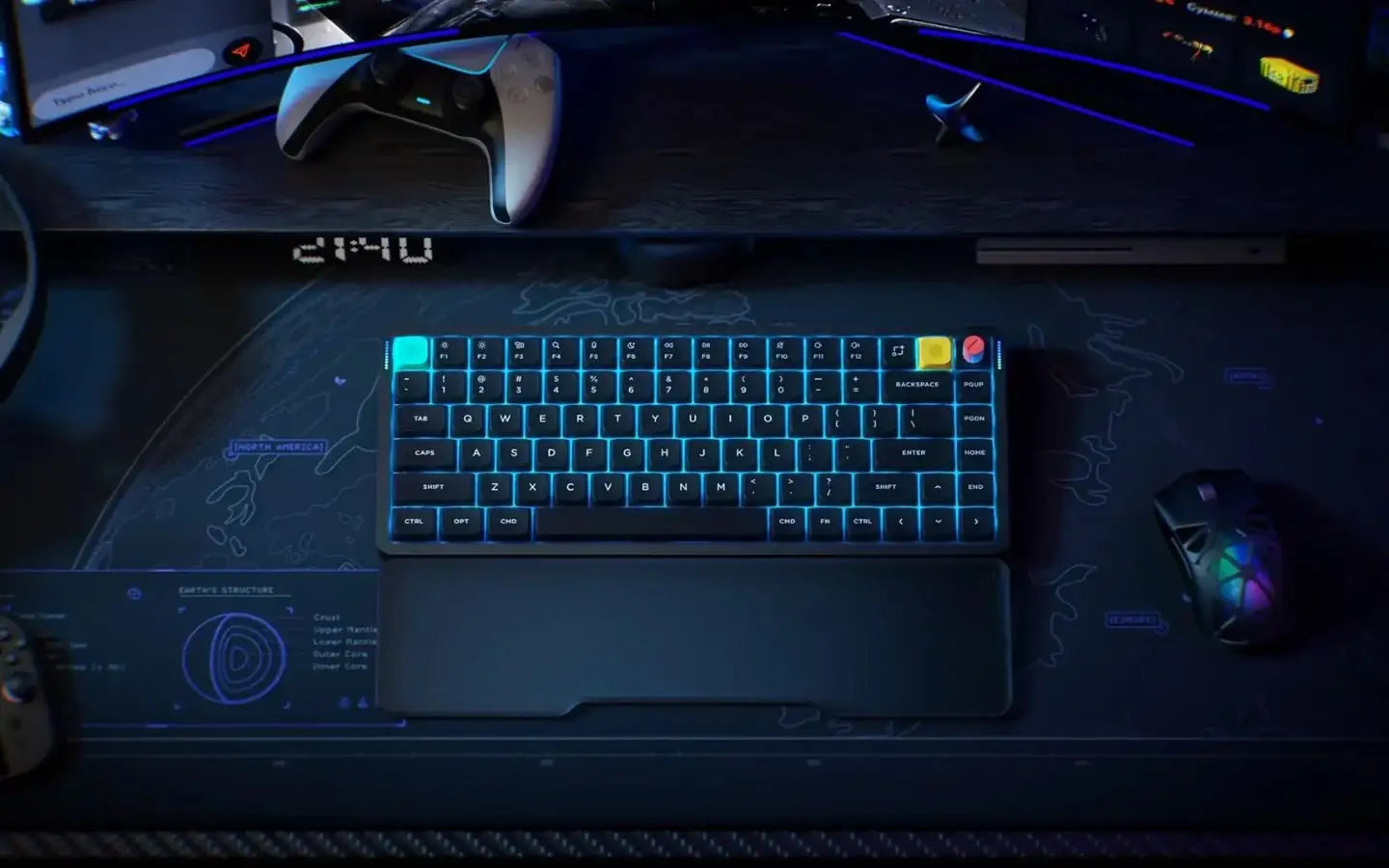 Podświetlana klawiatura mechaniczna RGB na biurku z podkładką mapą świata, obok mysz gamingowa i kontroler