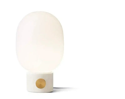 Minimalistyczna lampa stołowa z białym kloszem i betonową podstawą ze złotym pokrętłem