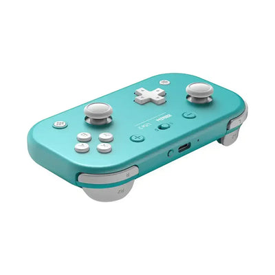 Turkusowy bezprzewodowy gamepad do gier, minimalistyczny design, przyciski i gałki analogowe.