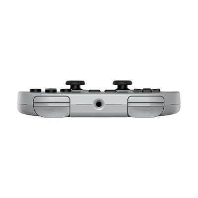 Szary bezprzewodowy gamepad do konsoli z przyciskami i wejściem audio, widok z góry.