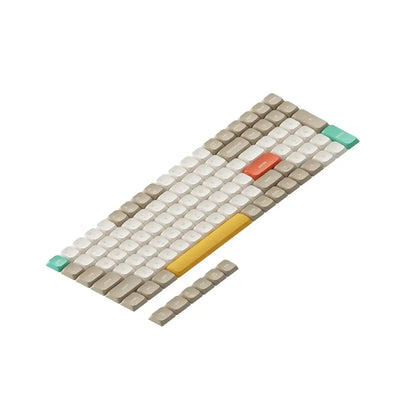 Zestaw keycapów do klawiatury mechanicznej w kolorach beżowy, biały, żółty, turkusowy, pomarańczowy.