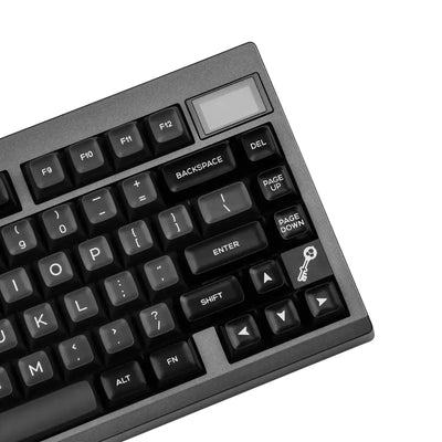 Czarna klawiatura mechaniczna z przyciskiem z symbolem klucza, widok z góry.