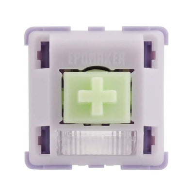 Mechaniczny switch do klawiatury w fioletowej obudowie z zielonym stemem, zbliżenie