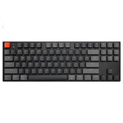 Klawiatura mechaniczna niskoprofilowa z czarnymi klawiszami, jeden pomarańczowy keycap.