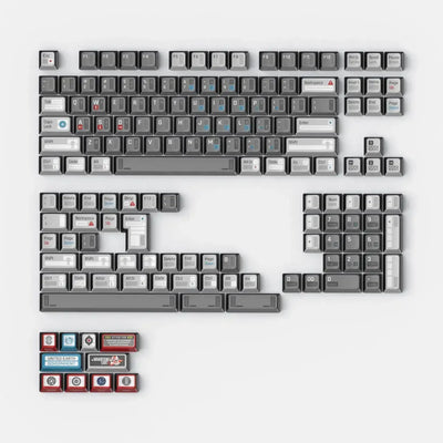 Szare i białe keycapy do klawiatury mechanicznej z czerwonymi i niebieskimi akcentami.