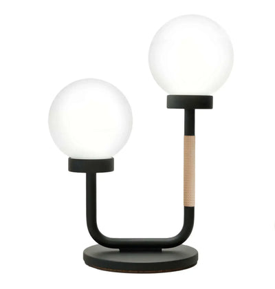 Designerska lampa biurkowa z dwoma szklanymi kulami na czarnej podstawie, idealna do home office
