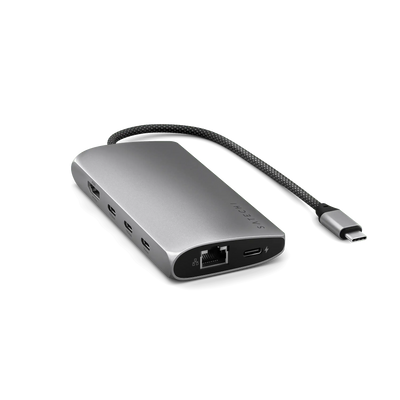 Srebrny adapter USB-C z portami HDMI, Ethernet, USB i czytnikiem kart, na czarnym tle